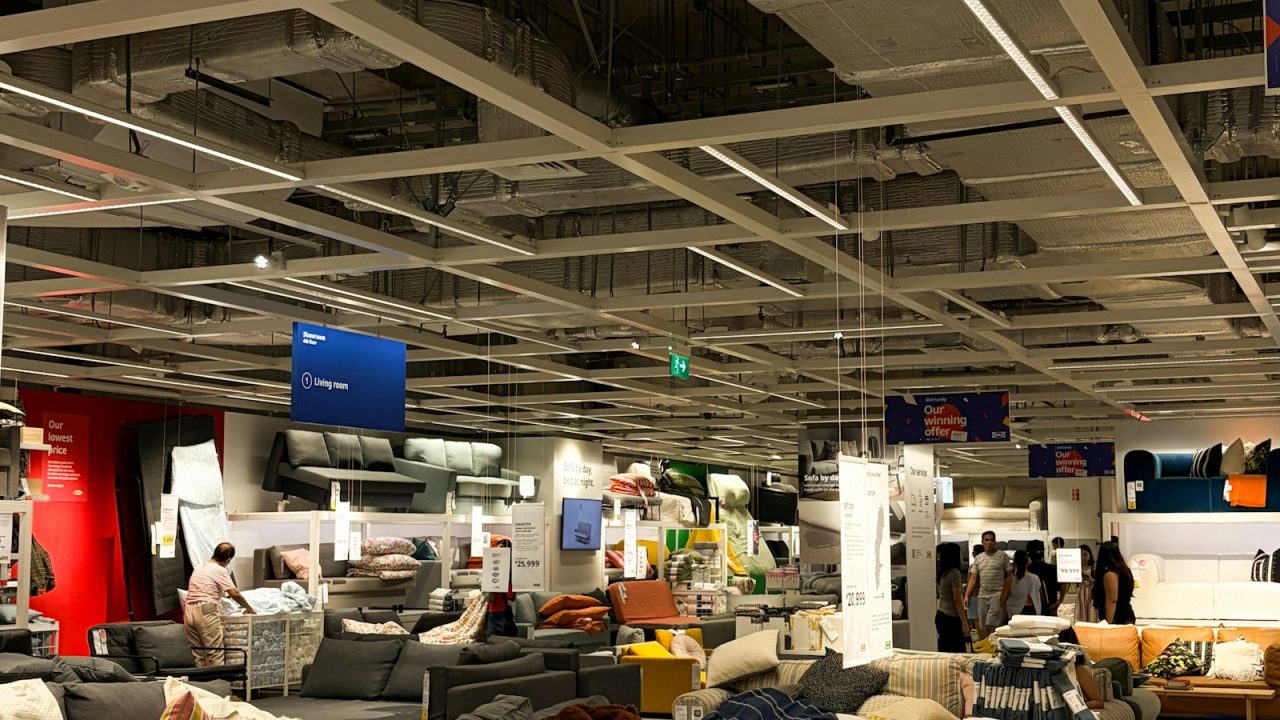 Rows of sofas displayed in a large, bright furniture store showroom
