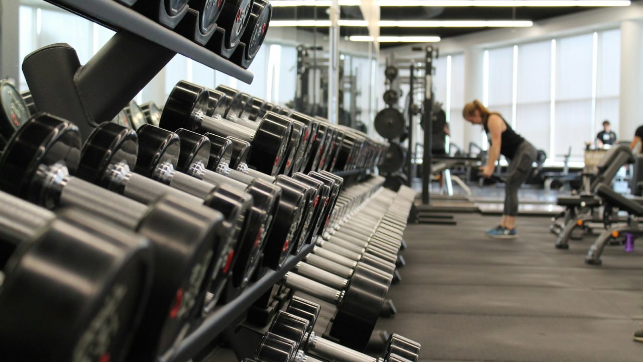 Modern gym interior with exercise equipment and warm ambient lighting