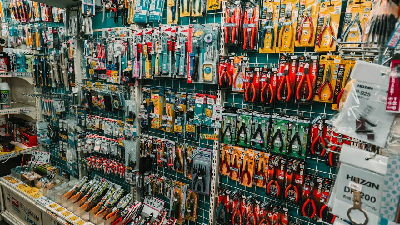 Wall display of assorted hand tools and hardware in a hardware store