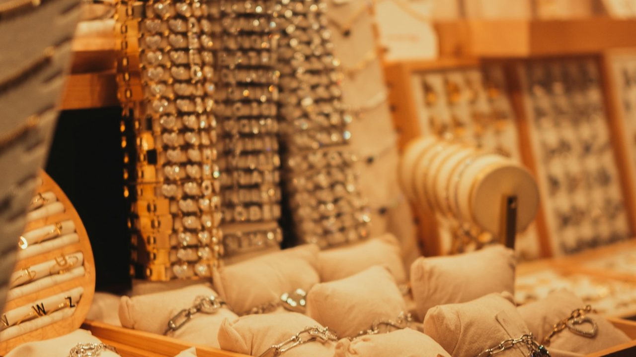 Glass display case filled with rings, necklaces, and other jewelry in a store